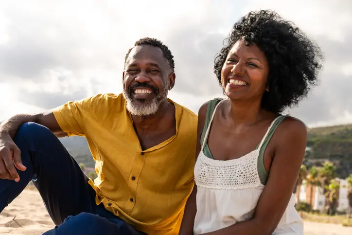Beautiful mature black couple of lovers dating at the seaside